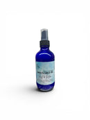 Blue spray bottle with a label on a white background