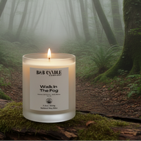 Candle with a label from B&B Candle Company on a log in the woods